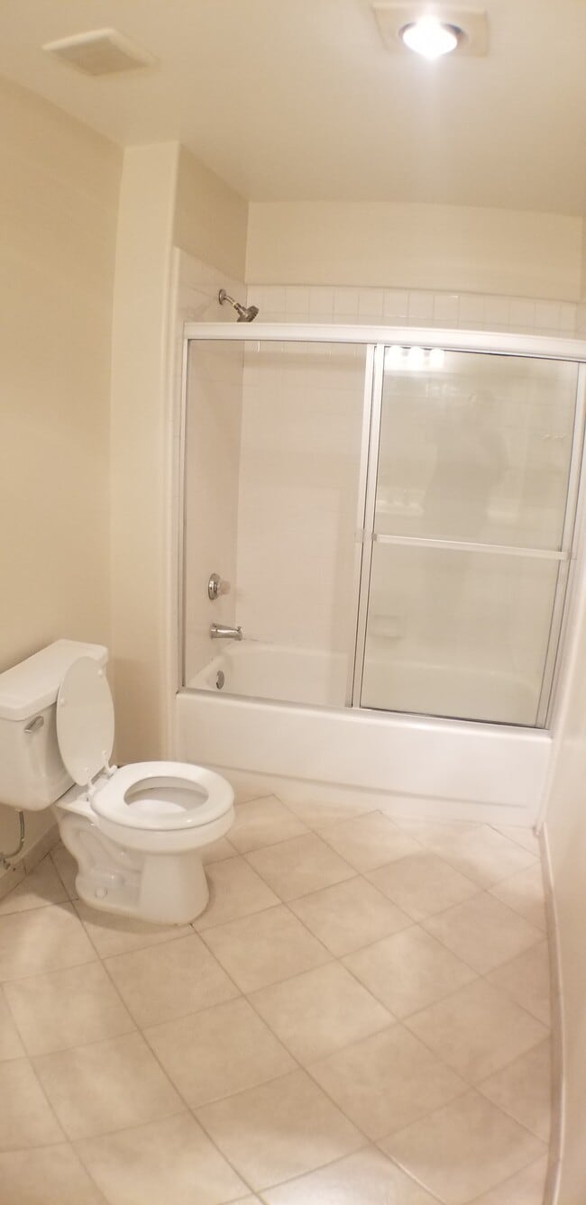 Master Bathroom toilet and bathtub including glass shower door - 14365 Foothill Blvd
