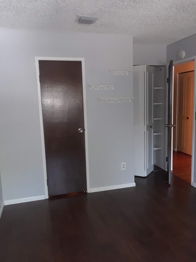 in bedroom, door to walk in closet and bathroom. door to hallway on right. - 3120 Corona Trl