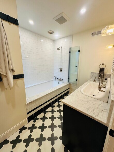 Bathroom #1 with oversized soaking tub, rain and standard shower heads, and double sink - 615 S Bambrey St