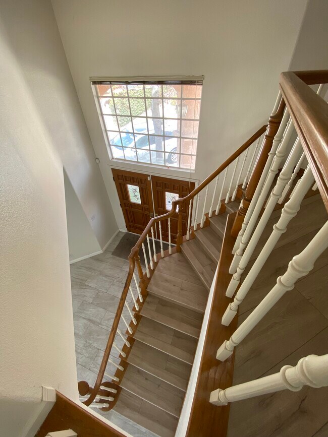 View of front entrance and stairs from landing - 915 W Arrow Hwy