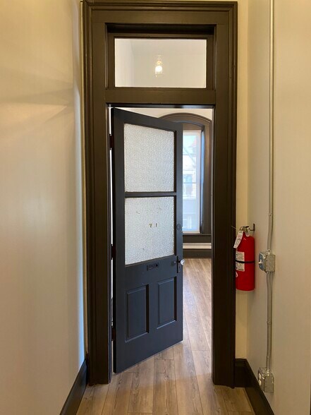 Original door leading to living room and kitchen. If you look close, you can still see Dr Reilly dentistry. - 102 S Main St