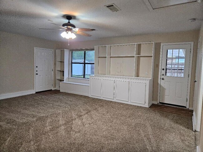 Building Photo - Three bedroom and two bathroom nicely remodeled with new flooring. Large wood fenced backyard