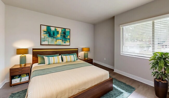 Bright and modern bedroom with stylish decor, featuring a cozy bed, elegant lamps, and vibrant wall art. - Soto Apartments