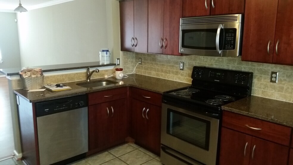 Completely upgraded kitchen with custom-cabinets, stone countertop, and all stainless steel appliances - 2469 Wentworth Drive