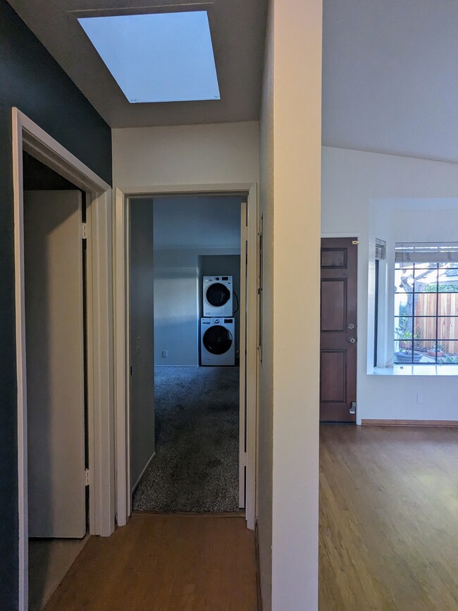 view from hallway of bathroom 2 and bedroom 2 with laundry nook - 4025 Via Diego