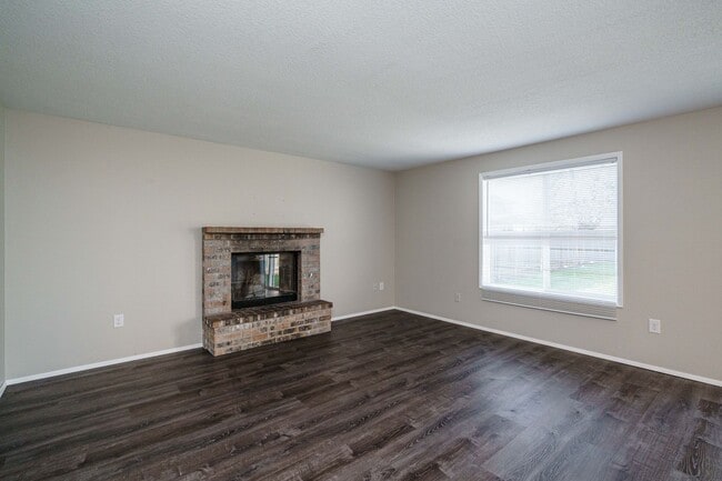 Building Photo - Recently Updated with Wood Laminate Flooring and Fresh Paint