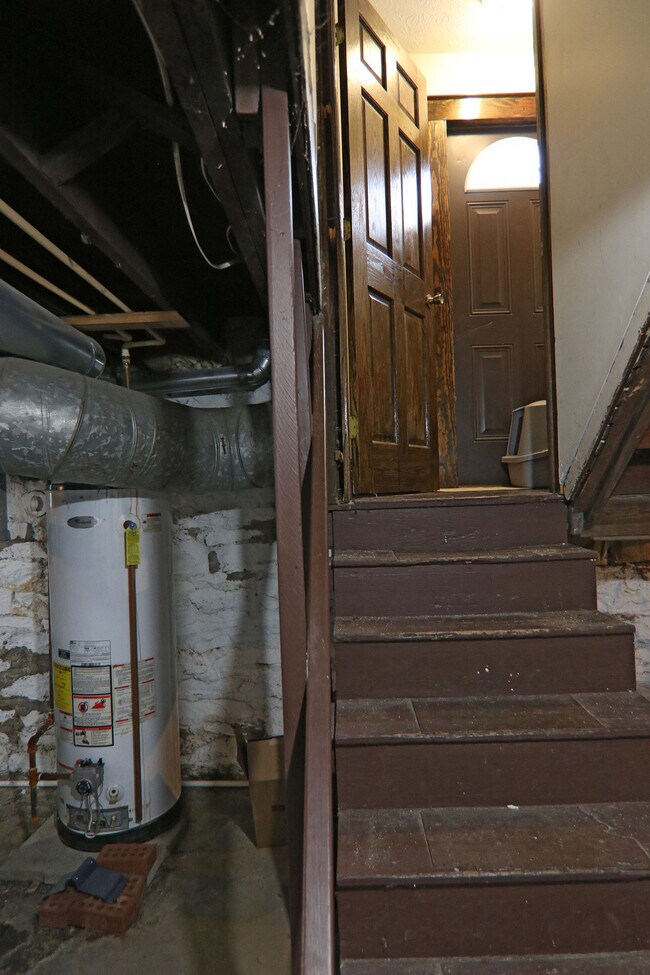 Going up from the basement with view of water heater - 372 E Oakland Ave