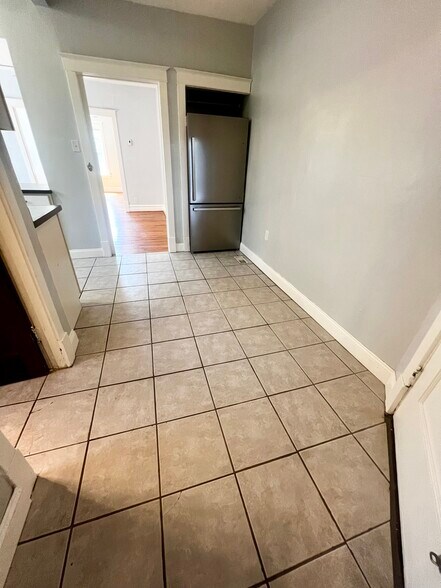 Brand new refrigerator tucked away for additional floor space. It has an ice maker. - 2107 Maury Ave