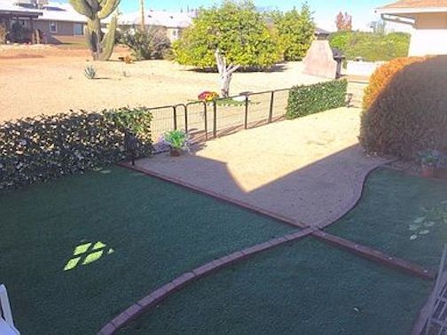 Attached fenced yard or pet pen area with feet pleasing, no maintenance artificial turf. - 12414 W Nugget Ct