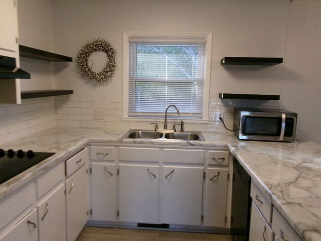 Building Photo - Classic brick rancher with carport and updated decor