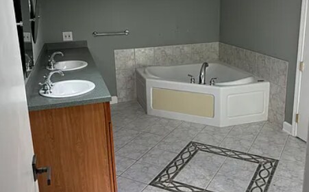 Full bathroom upstairs; two sinks, large bathtub, and shower with two showerheads - 207 Edgedale Dr