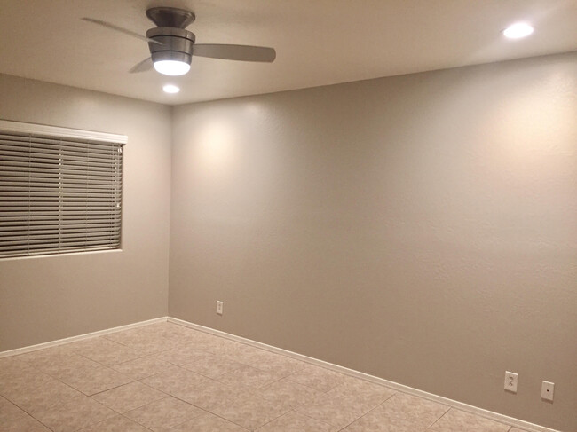 Master Bedroom with ceiling fan, ceiling lights on dimmers, and two closets! - 4701 N 68th St