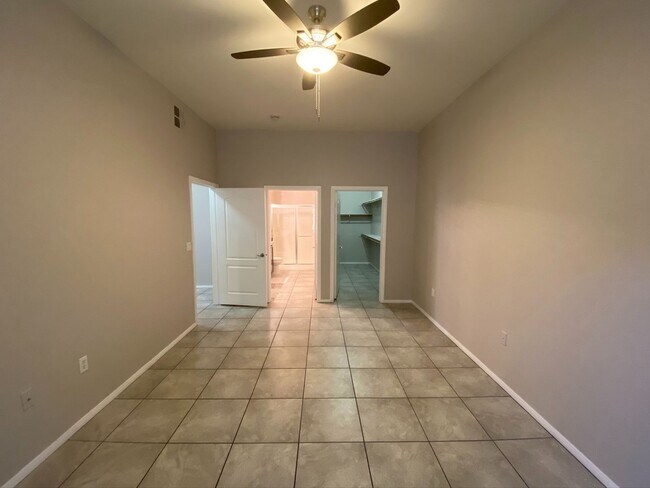 Building Photo - BEAUTIFUL CONDO IN A GATED COMMUNITY FEATURING PLANTATION SHUTTERS, TILE FLOORING AND NEW PAINT T...
