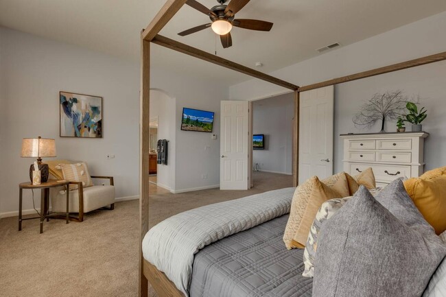 Master bedroom with Firestick TV, sitting area, ensuite bath, and large walk-in closet - 1698 Gemtown Dr