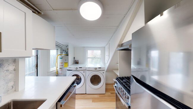 Kitchen with cabinets, refrigerator, stove, range hood, and sink - 2129 Haste Street