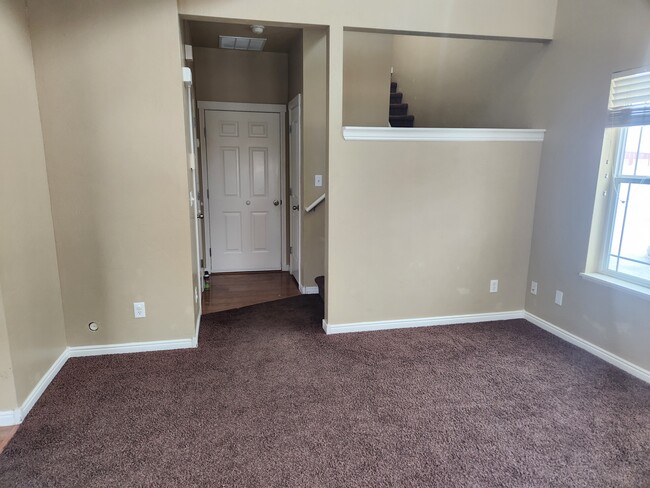 View of living room from front door. Guest bath door on left, garage door center, closet door on rig - 1584 N 565 W