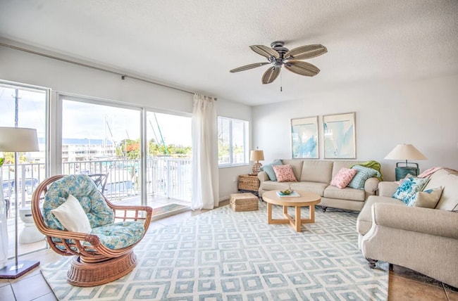 View from wall to living area-- sliding glass leads to porch and spiral stair - 96 Ave C