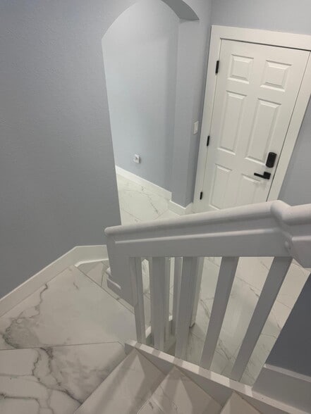 view of stairs opening to garage - 11300 SW 236th Ln