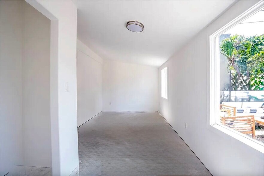 The secure private 200 sq ft bonus room is a blank canvas! Bring your own set up or use for storage. - 2824 S Orange Dr