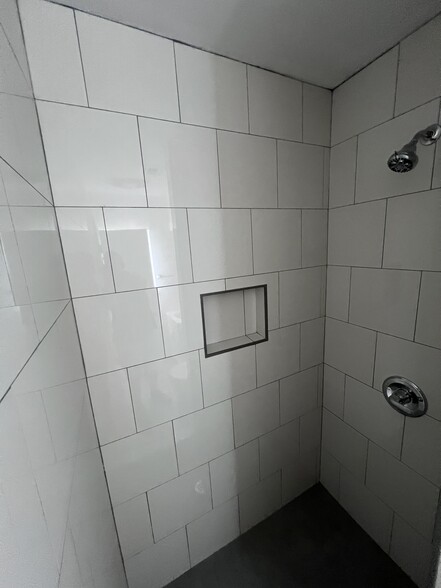 Newly tiled shower in primary bath - 415 W Guthrie St