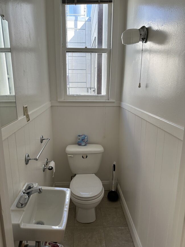 Half Bath : toilet and small sink. - 1271 10th Ave