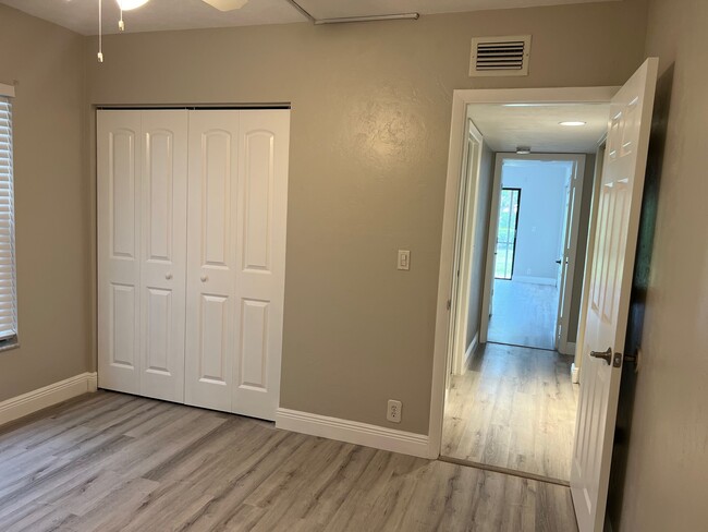 Second bedroom closet and view of hallway - 1733 Courtyard Way