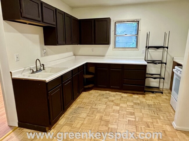 Building Photo - This 3-bedroom 1-bathroom house has a large front yard and a mostly fenced backyard.