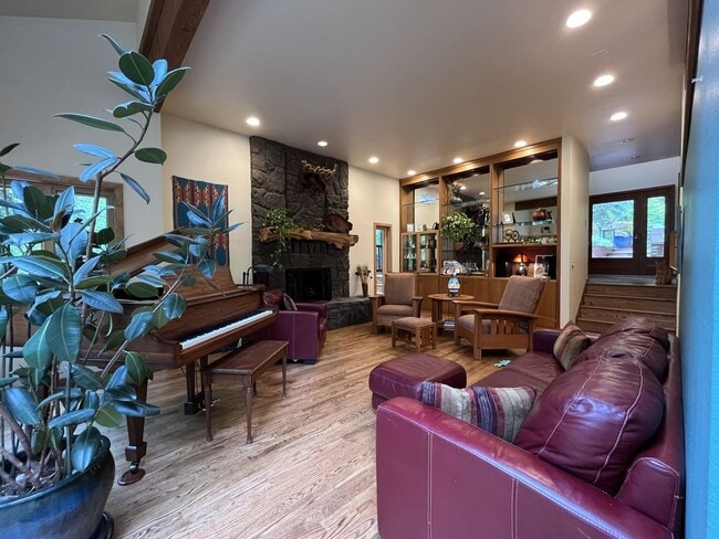 Building Photo - One-of-a-Kind Custom Home with Wall of Windows, Stone Fireplaces, Expansive Entertainment Space &...