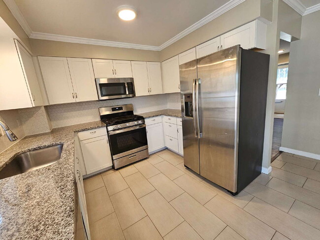 Building Photo - Clean 3-Bedroom Tri-Level, 1.5 Bath with Updated Kitchen, Great Room, Fireplace & Private Backyar...