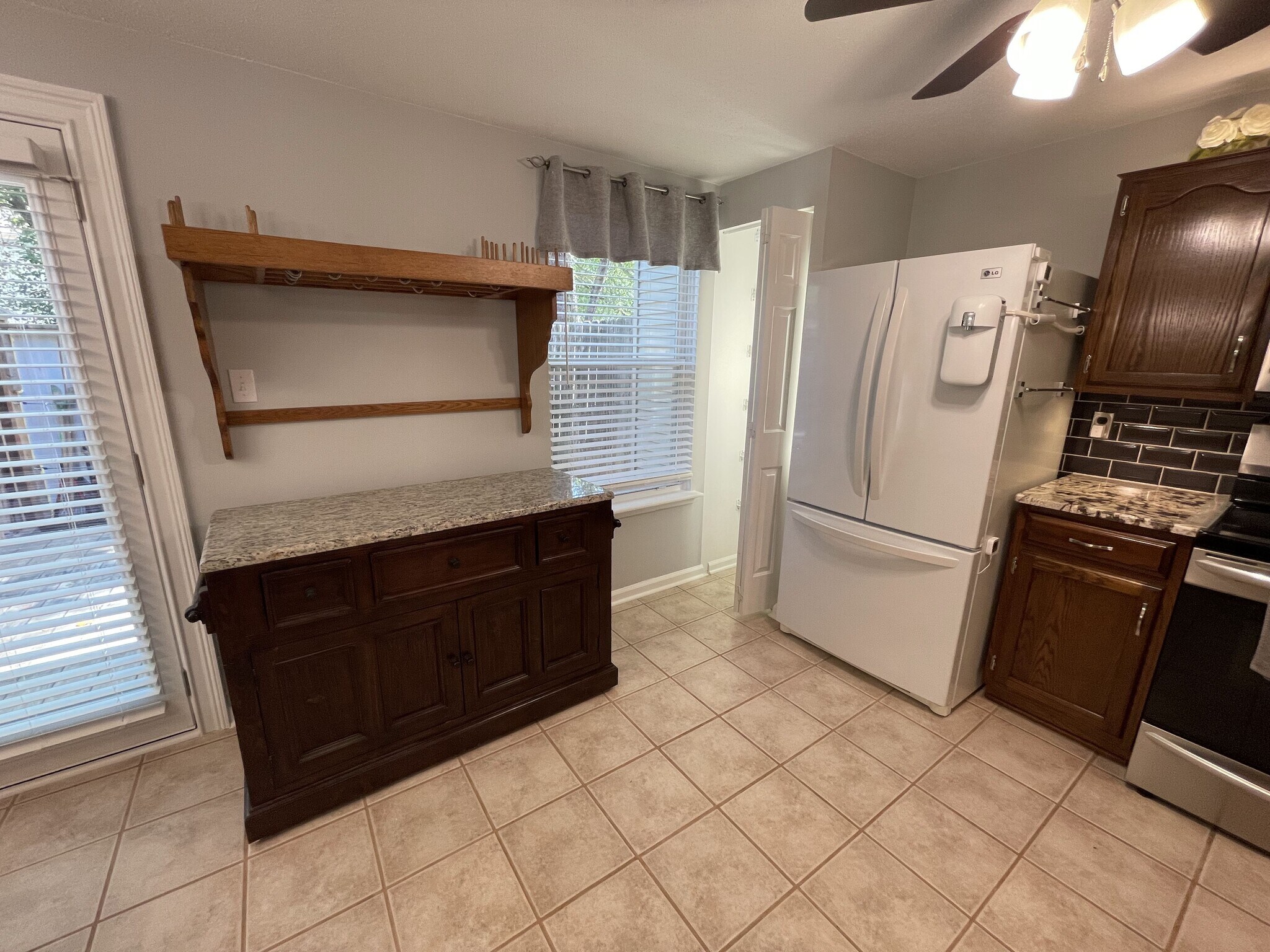 Kitchen with custom pot rack and center island relocated, pantry with bright linear lighting - 4204 Whistler Ct