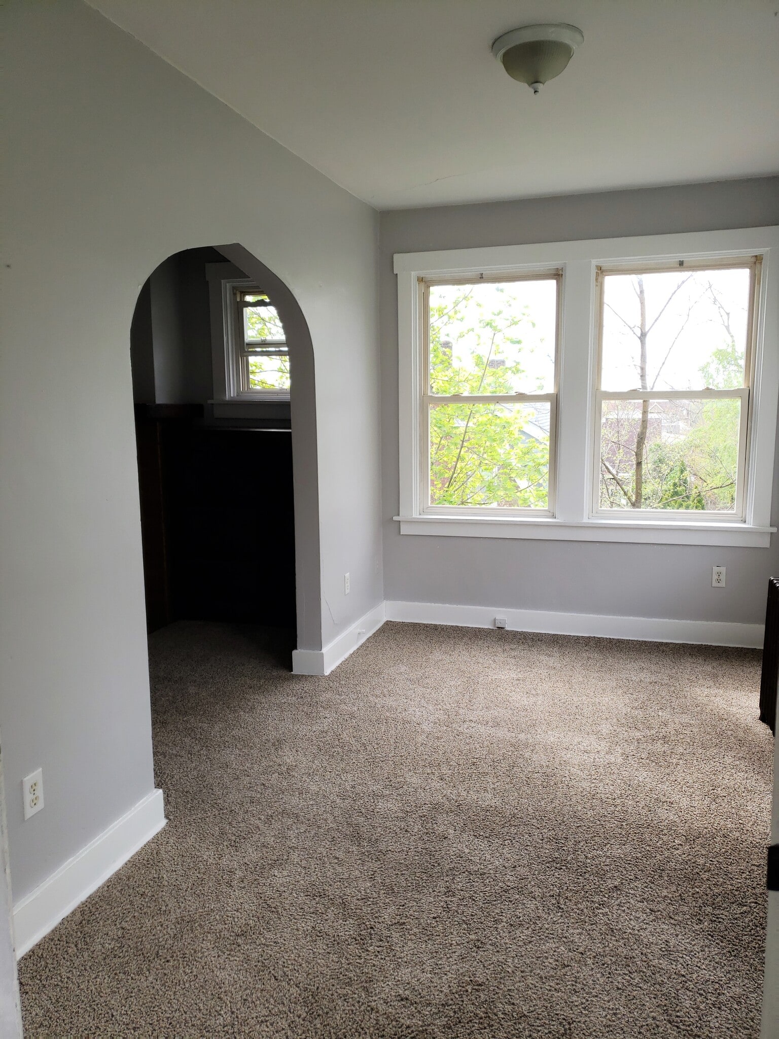 The sun-room enter into the living room through the archway - 201 Richbarn Rd