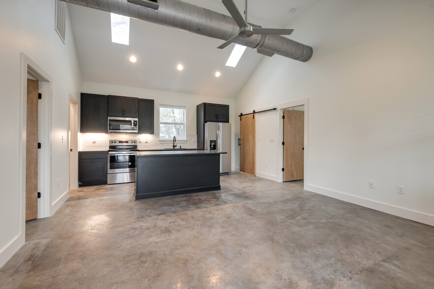 Open living room to kitchen with vaulted ceilings and skylights - 320 Rose St