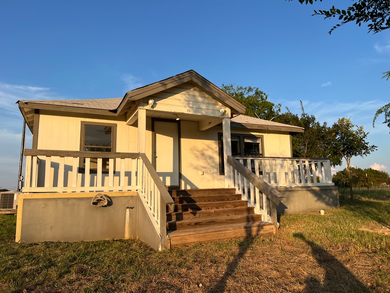 Front of house with large deck covered in center - faces large field and Sunset - 2900 County Road 285