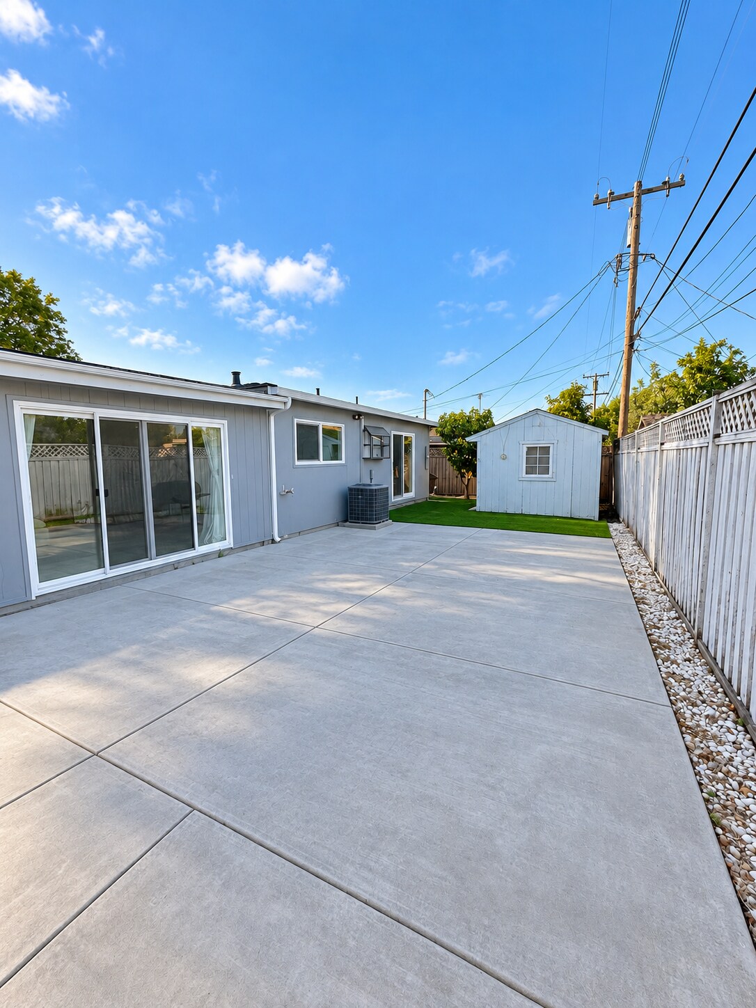 Large private backyard with spacious paved patio and low-maintenance landscaping. - 826 San Pablo Ave