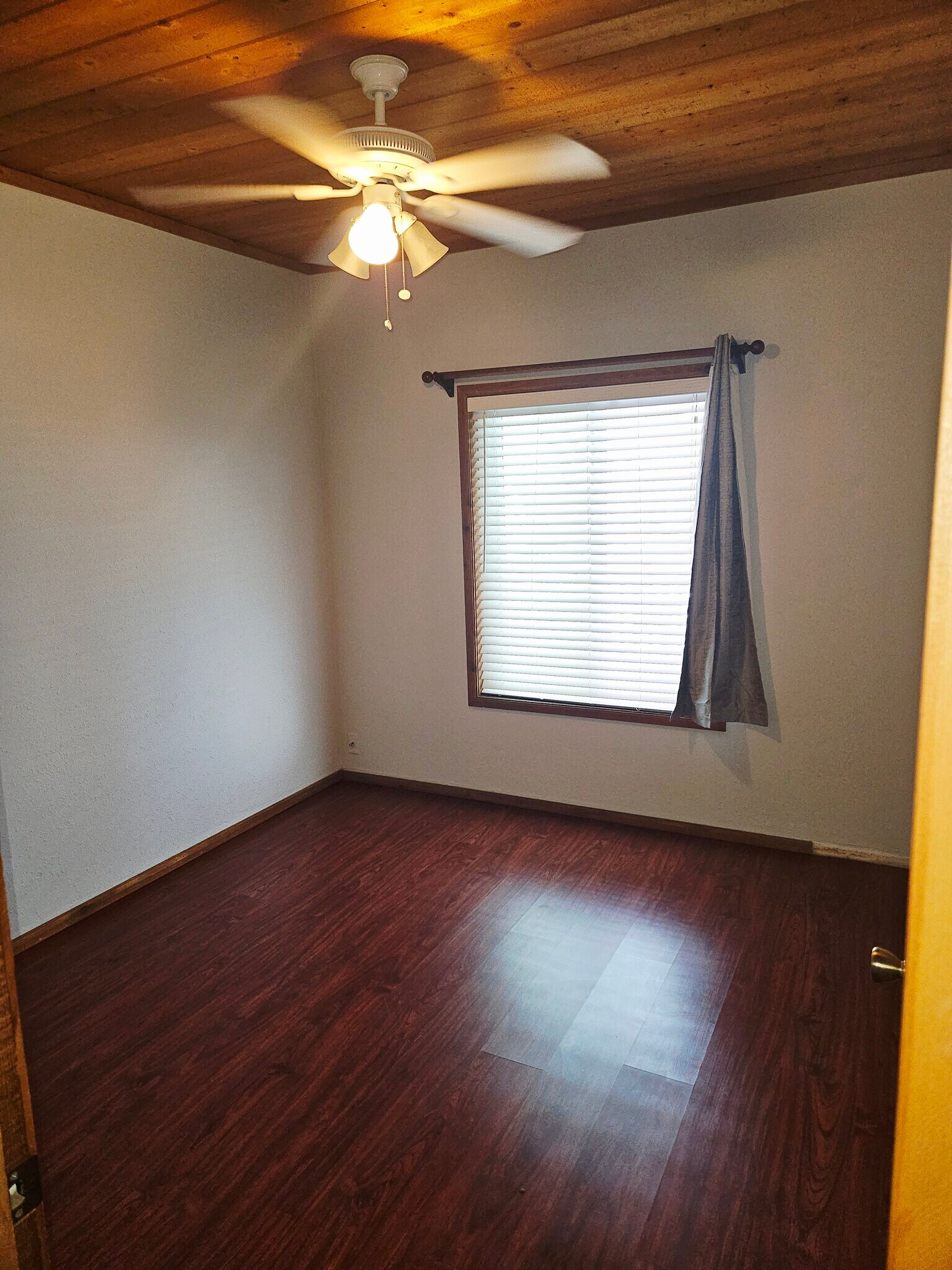 Bedroom with wood laminate flooring. - 934 S Myers St