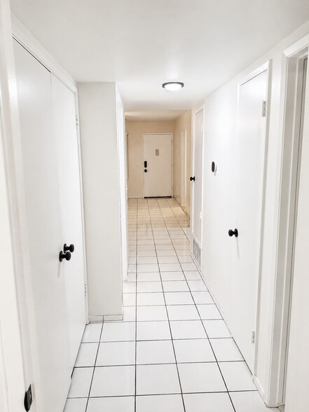 Bright interior hallway with tile flooring and access to bedrooms, bathrooms, and main living areas. - 339 E Taft Ave
