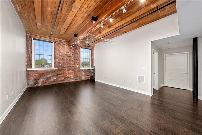 Building Photo - Stylish Industrial Loft with Exposed Brick, High Ceilings & Modern Kitchen