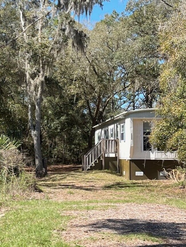 Building Photo - Charming 2-Bedroom Home on Spacious Wooded...