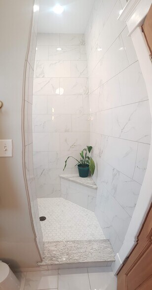 Master bath shower with bench, shelving, rain shower head and hand held shower head. Sorry for the picture distortion it is difficult to capture in a photo. - 407 S. 6th Street
