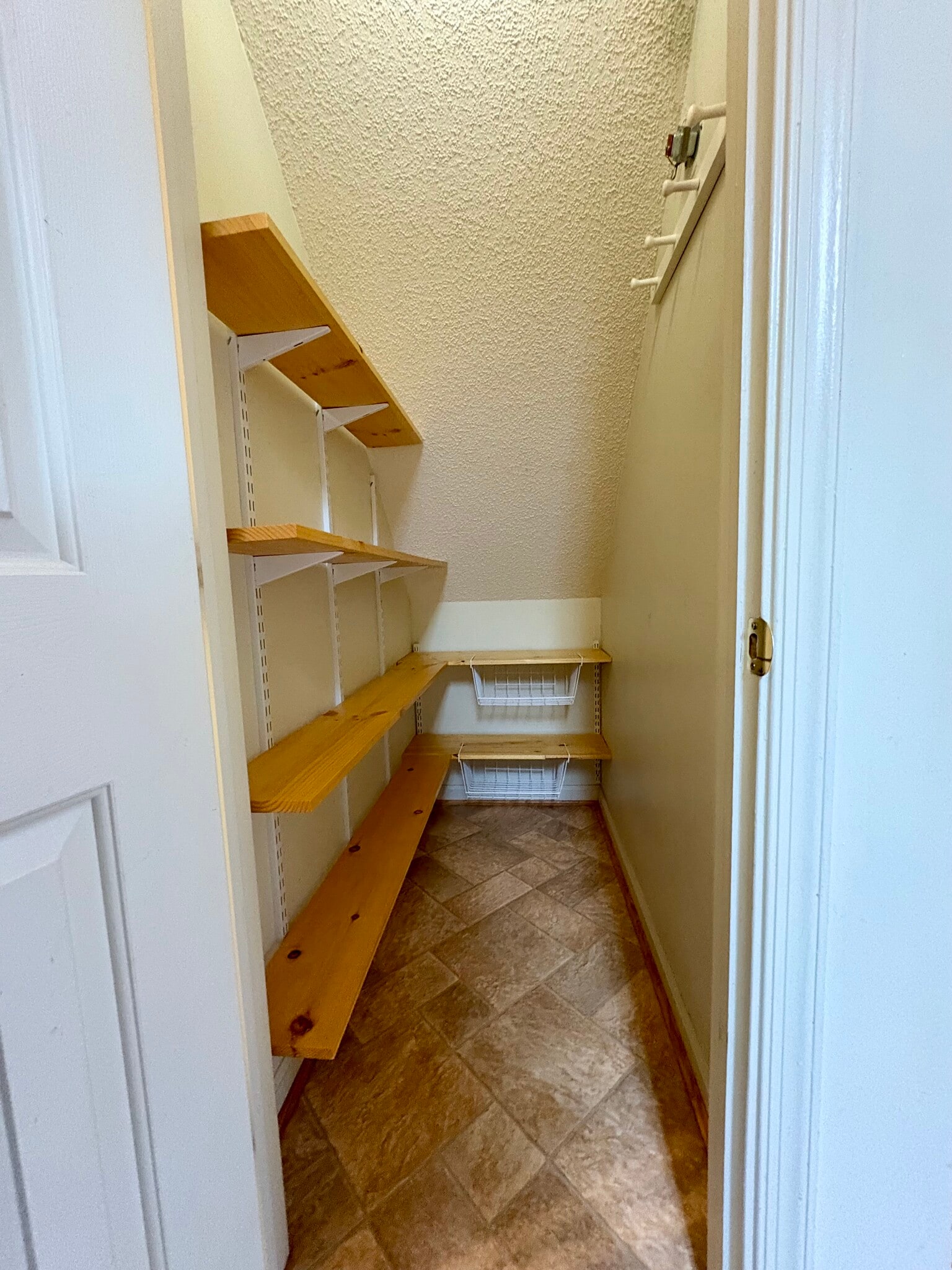 Ample pantry storage under the stairs, beautiful wooden shelves - 208 Quarter Trl
