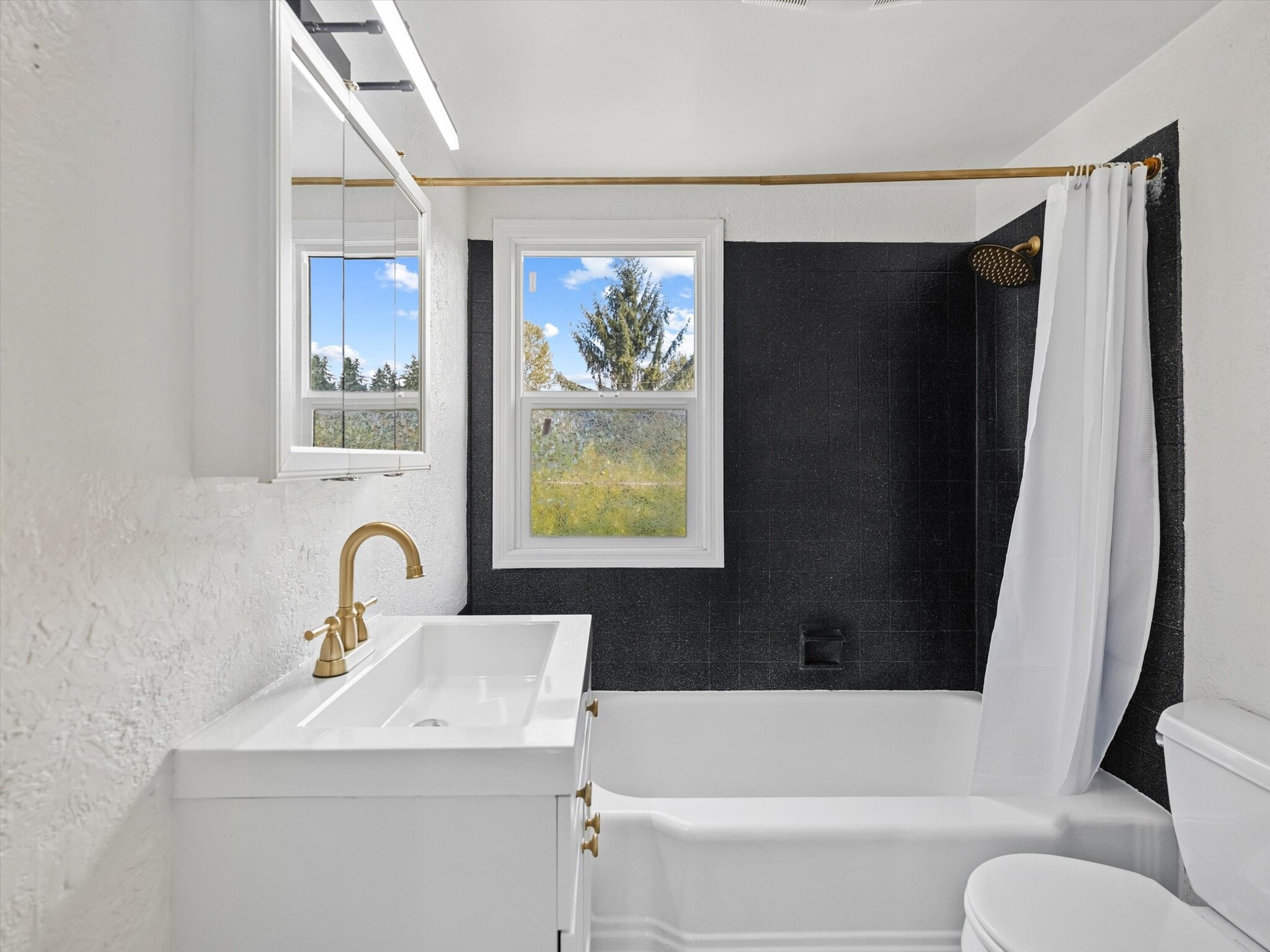 The recently remodeled bathroom features a shower tub. - 9835 SW 80th Ave