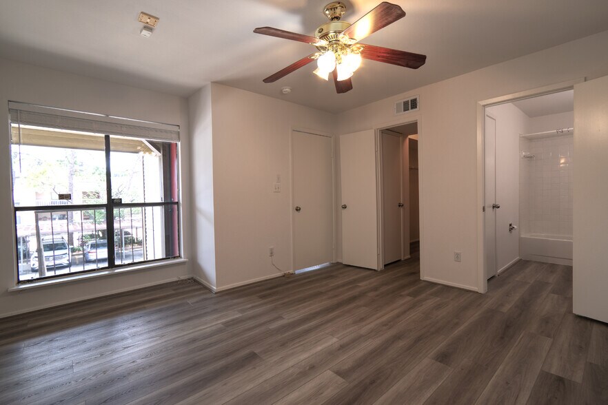Secondary Bedroom, seen from the southeast corner, featuring a window that faces South. - 2025 Augusta Dr
