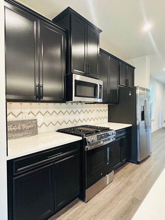 Building Photo - New Construction • 4 BR • 2 Full / 2 Half BA • End Unit Townhome in Village Town – Fayetteville’s...