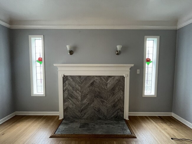 Building Photo - Three-Bedroom Home with Updated Kitchen & Vaulted Ceilings, large open basement, Hardwood floors