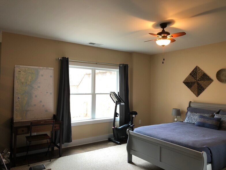 Bedroom area with exercise bike and desk - 2850 Salem Rd