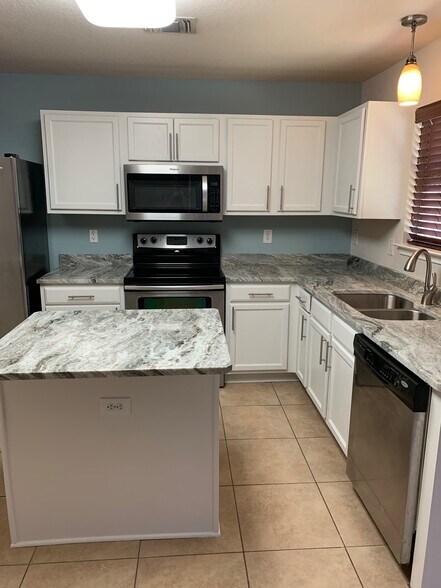 New granite counters, sink, fixtures, and freshly painted cabinets - 10219 Roseangel Ln