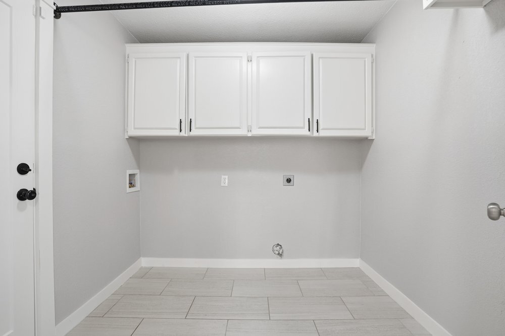 Laundry Room ft. Large upper cabinets, and hang to dry bar above. Washer and dryer hookups only - 14548 W 19th St S