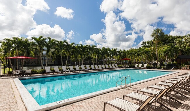 Enjoy a day poolside. - Plantation Gardens Apartment Homes