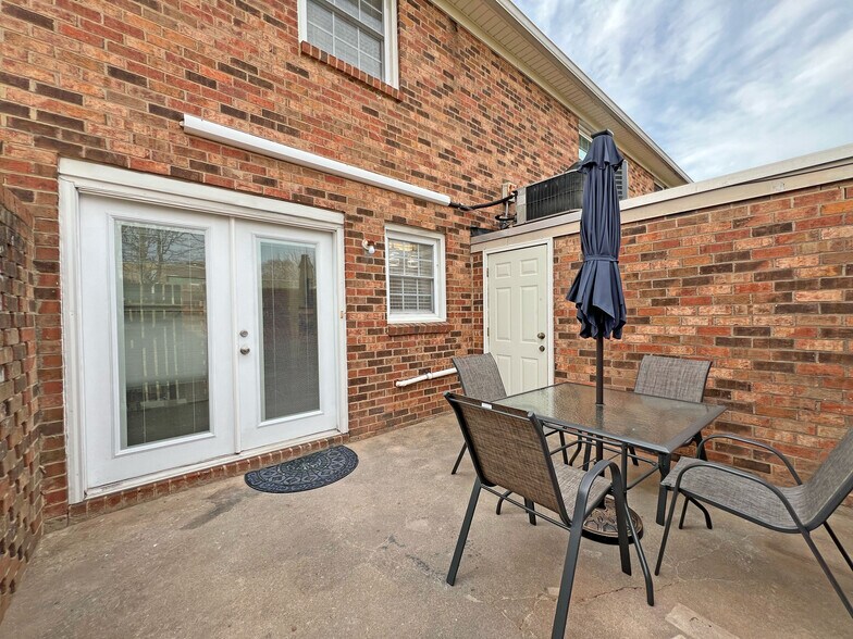 Spacious patio w/4-top table and 7 ft umbrella w/solar lighting / Access door to laundry room - 160 17th Street Pl NW