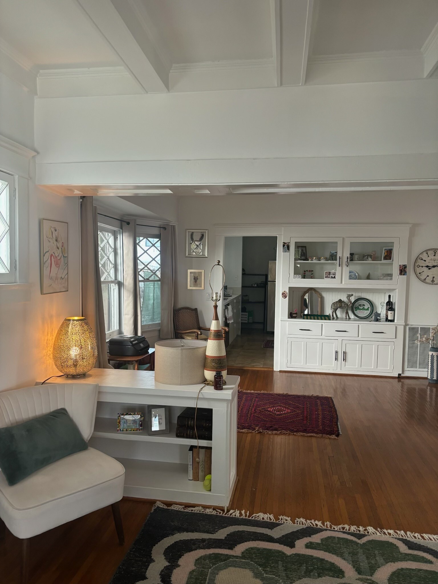 Bright and open living room with built-in shelving and period details. - 6000 Carlton Way